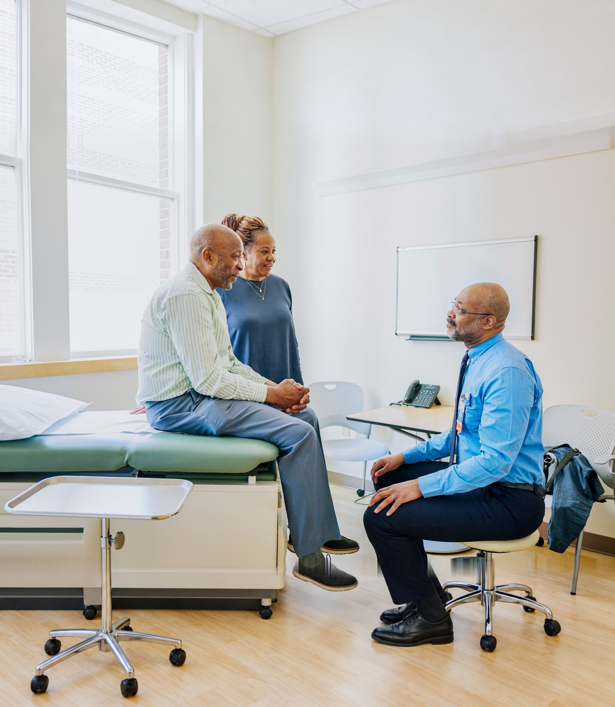 Doctor speaking with a patient and companion